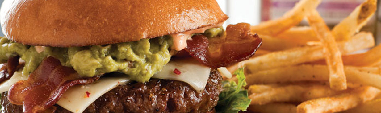 Gourmet burger with guacamole and pepper jack cheese